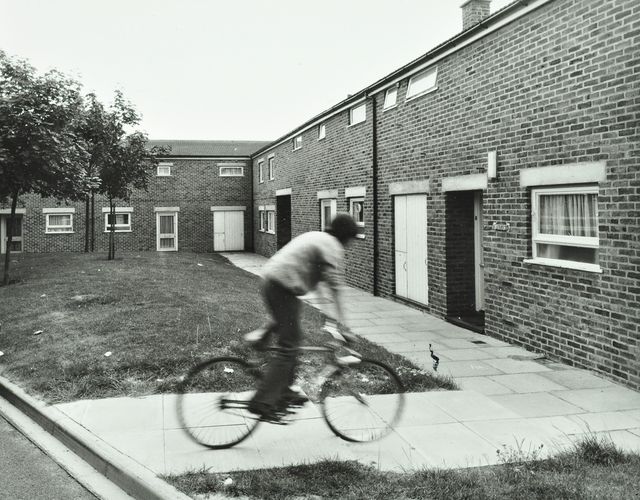 Andover: boy rides a bicycle on a housing estate, image © London Metropolitan Archives (City of London).